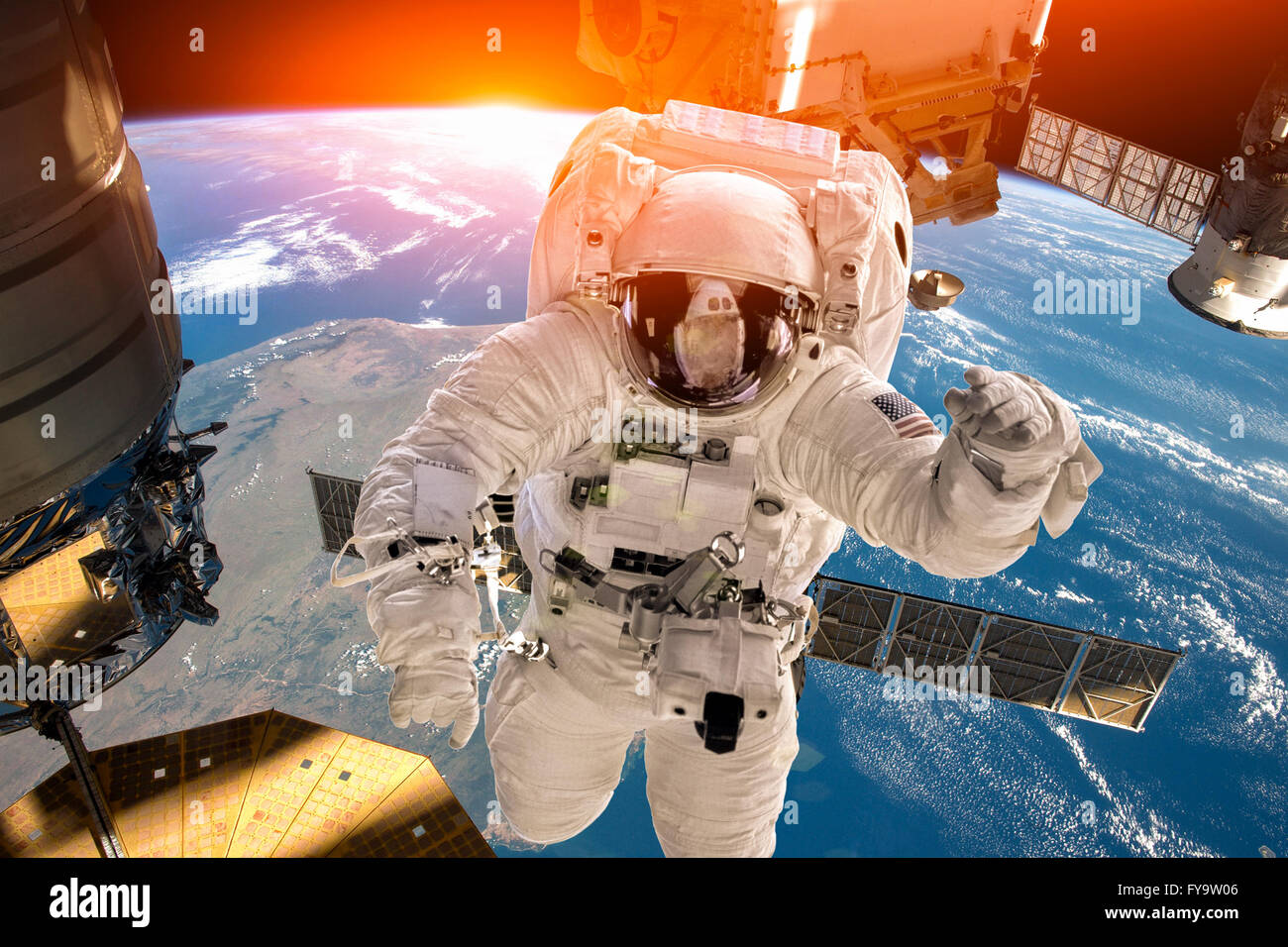 International Space Station and astronaut in outer space over the planet Earth. Elements of this image furnished by NASA. Stock Photo