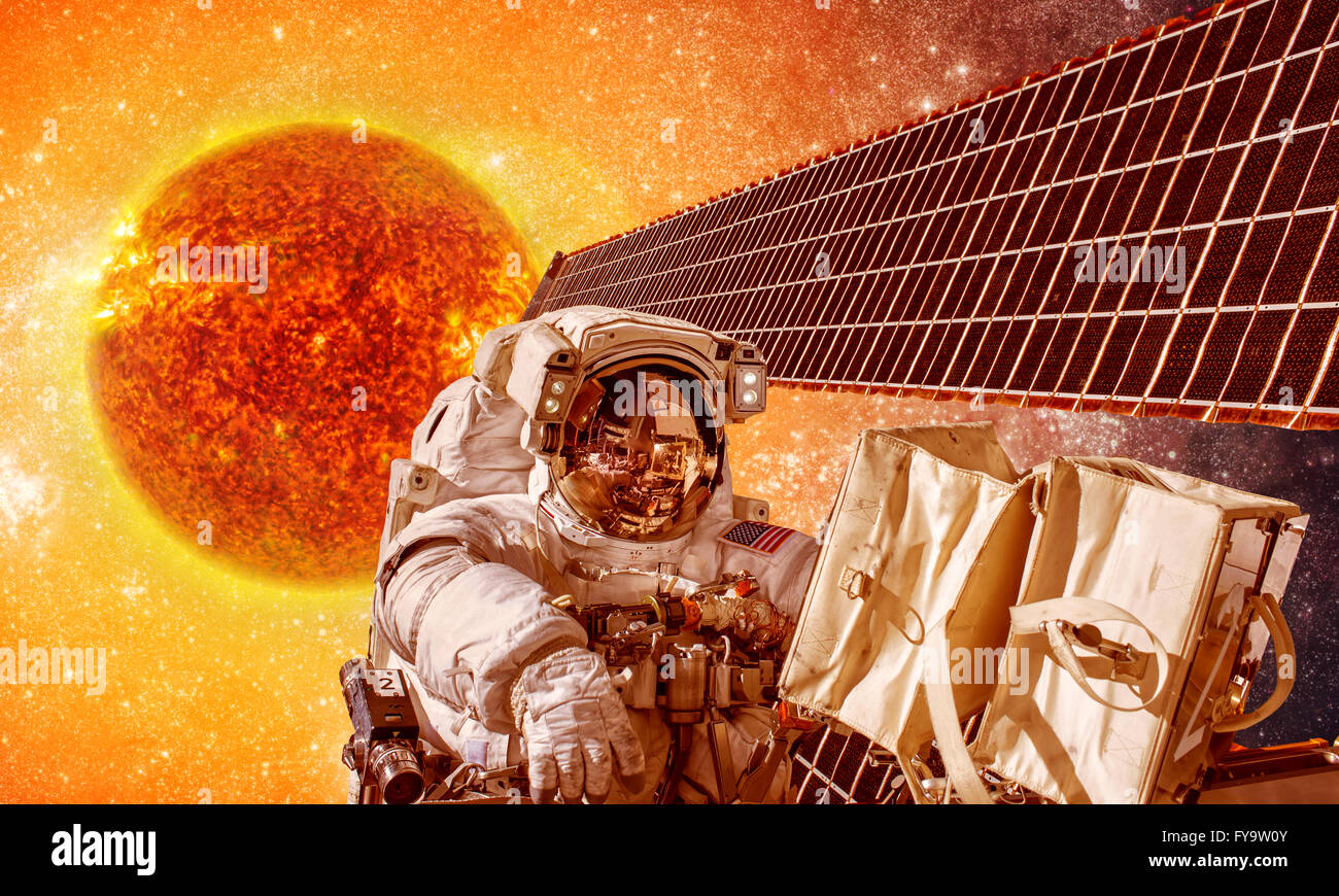 Spacecraft and astronauts in space on background sun star. Elements of this image furnished by NASA. Stock Photo