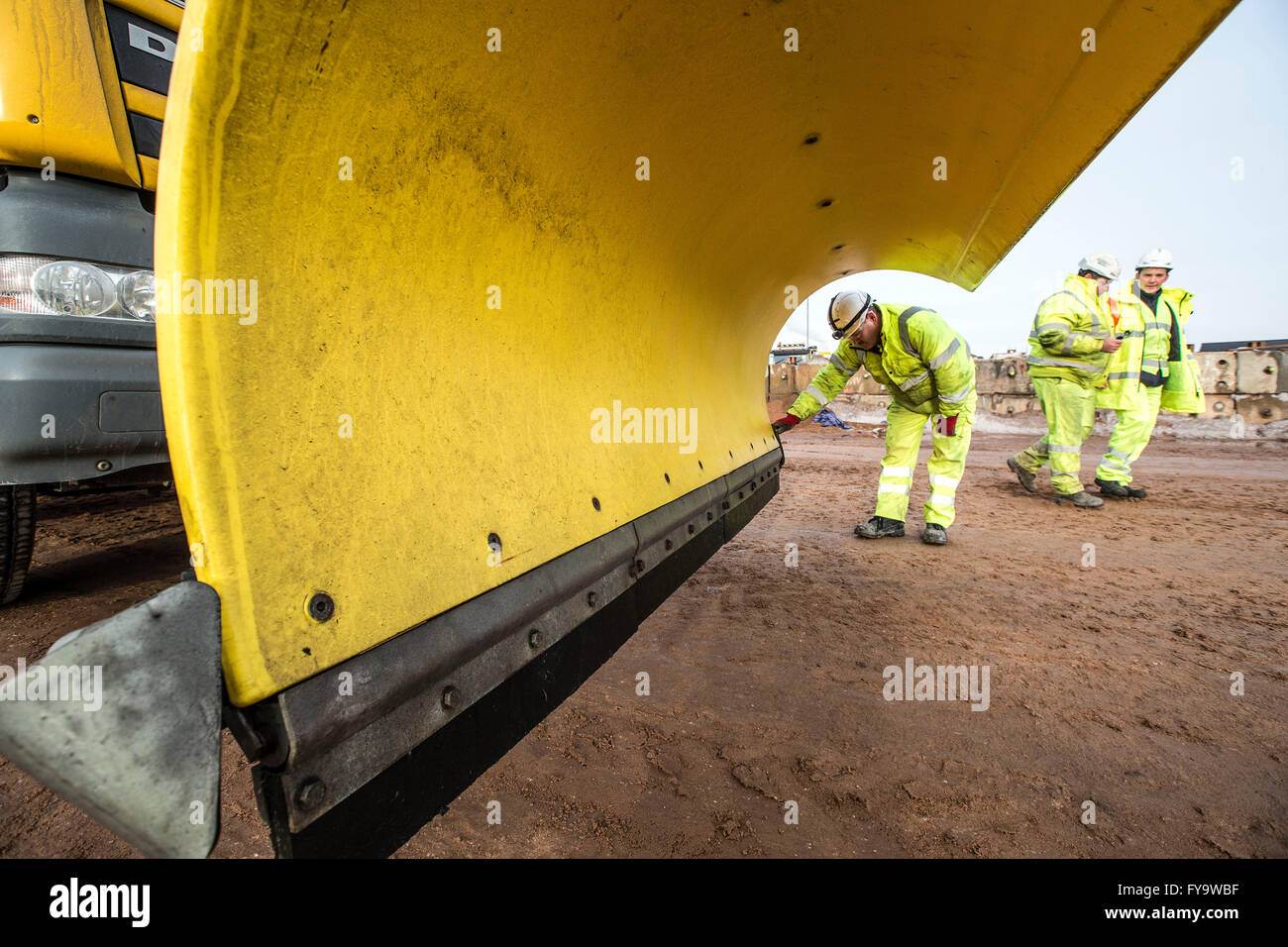 Operators checking the scoop on gritters Stock Photo