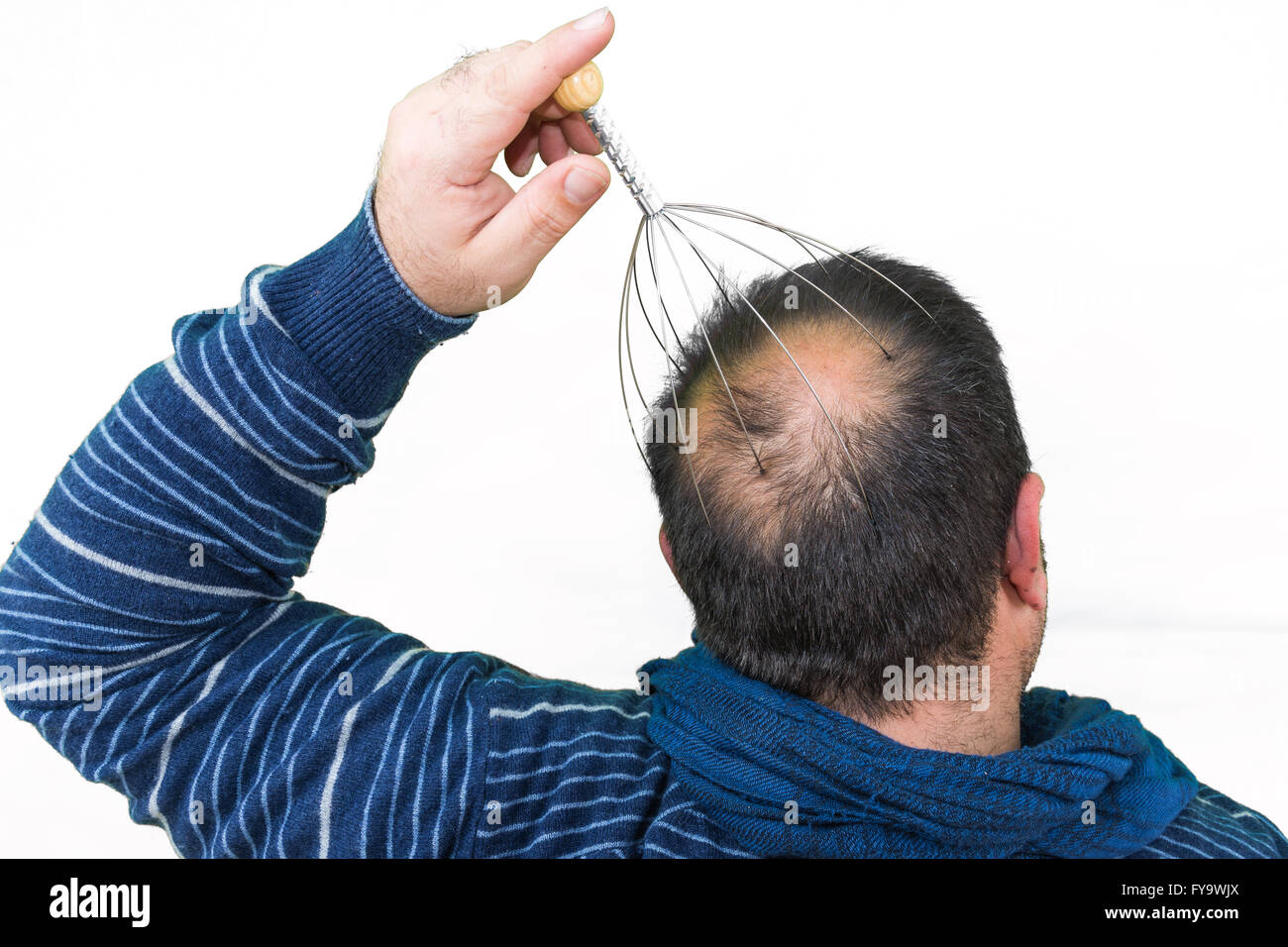 Man relaxes with the Genie head massager. Alternative Therapy. Indian head  massage tool, self head massager Stock Photo - Alamy