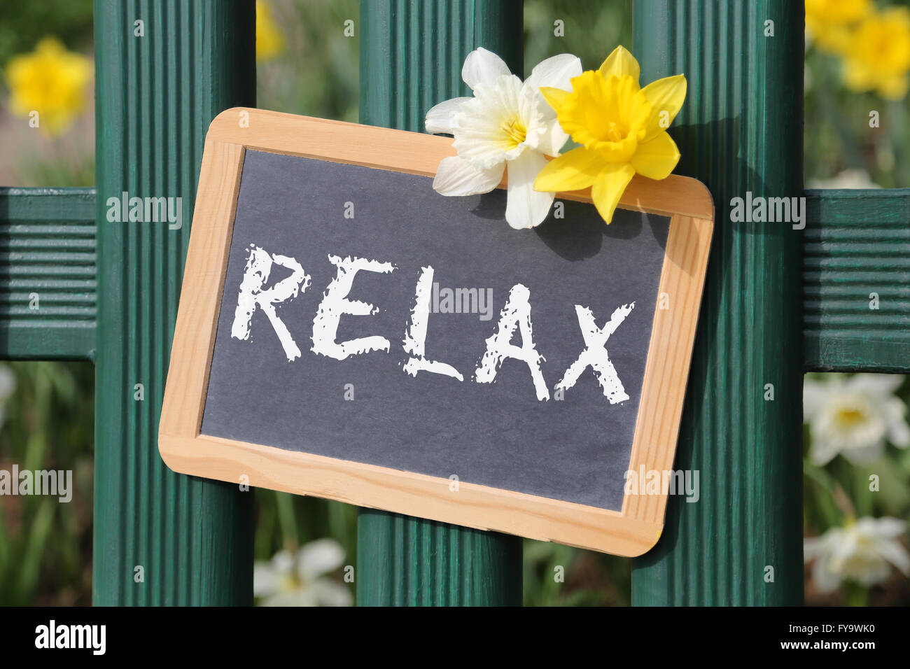 Relax relaxing garden with flowers flower spring sign board on fence Stock Photo