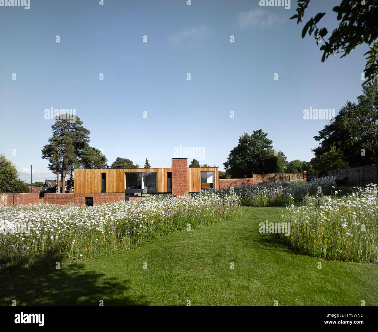 A modernist house set on a historic walled garden with a wild flower