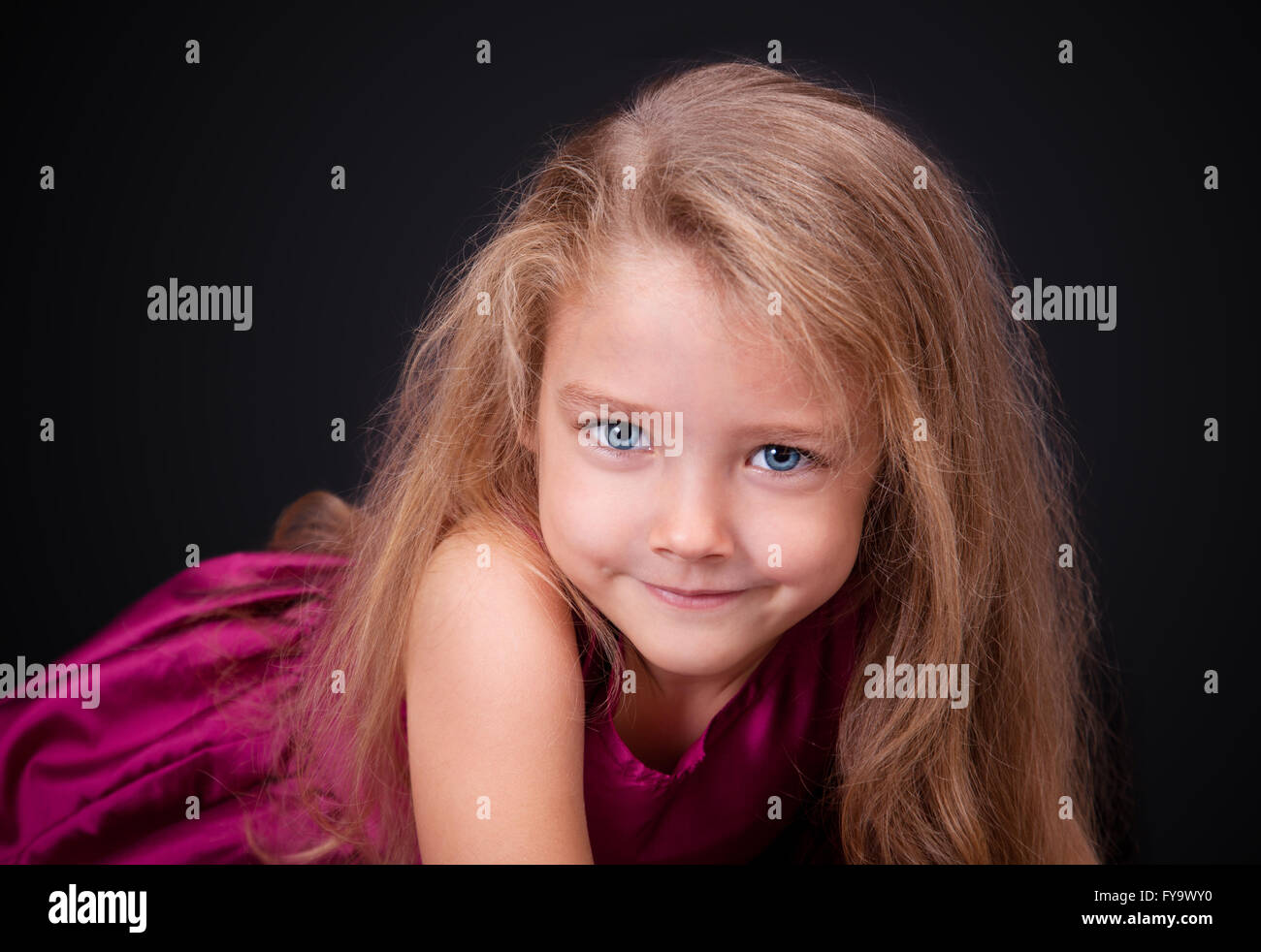 Portrait of a cute little girl in a pink dress in the studio Stock ...