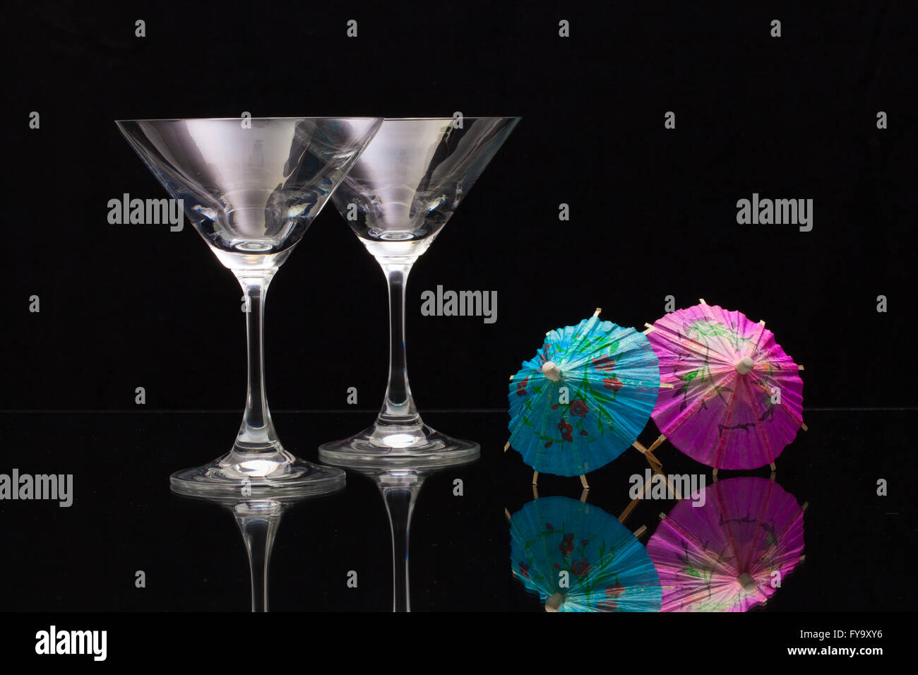 Two empty glasses of champagne with decoration (paper umbrellas Stock