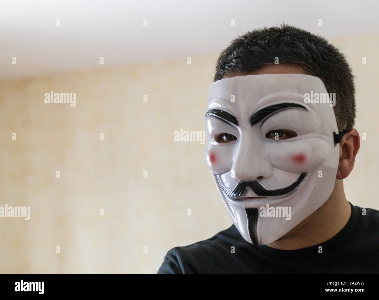 Man wears a Guy Fawkes Mask popular with anonymity to disguise his