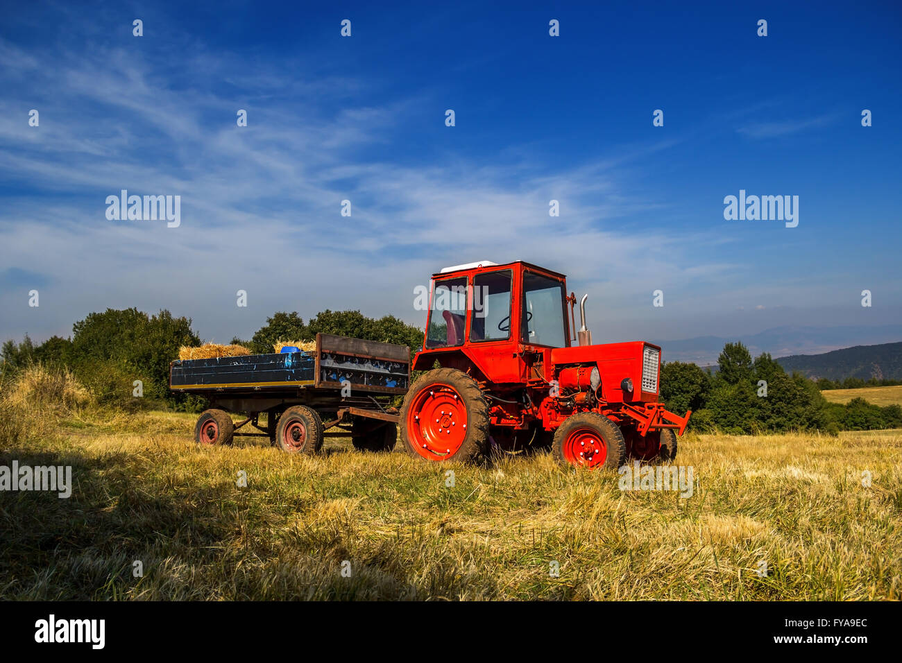 Old red tractor on the agricultural field in autumn Stock Photo - Alamy