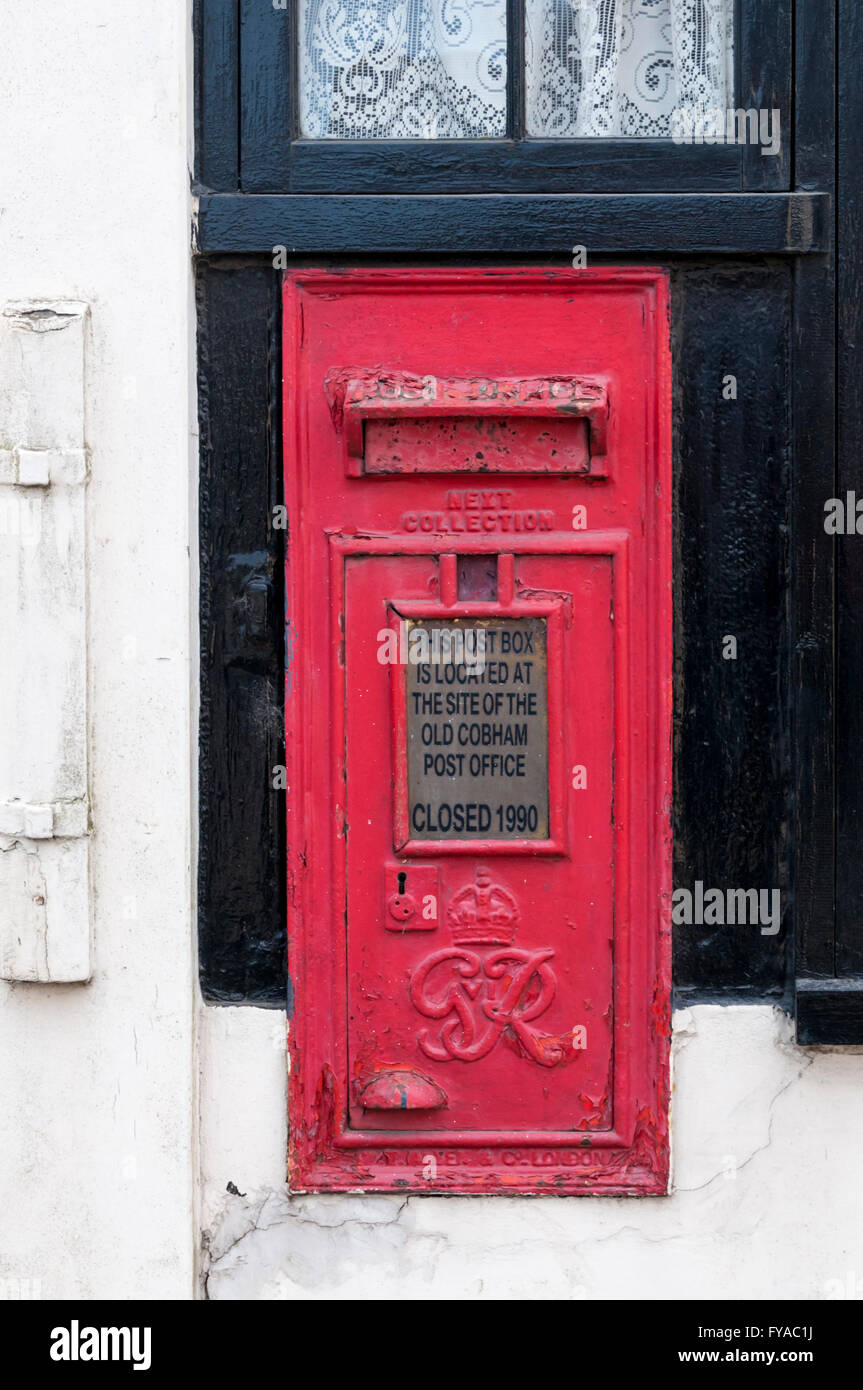 A post box on the old Post Office in Cobham, Kent. Stock Photo