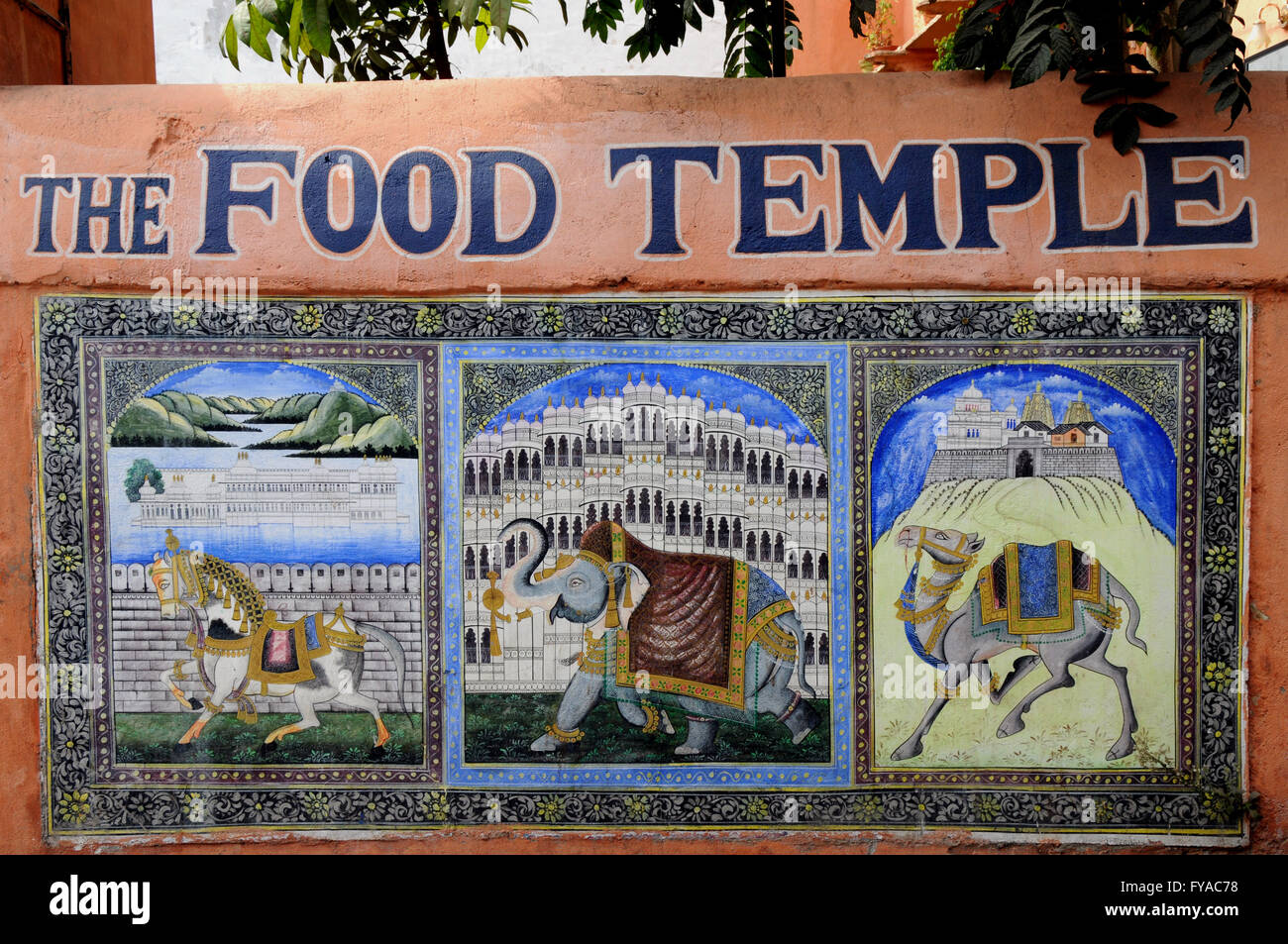 A wall painting advertising a vegetatian restaurant in the city of Udaipur, Northern India. Stock Photo