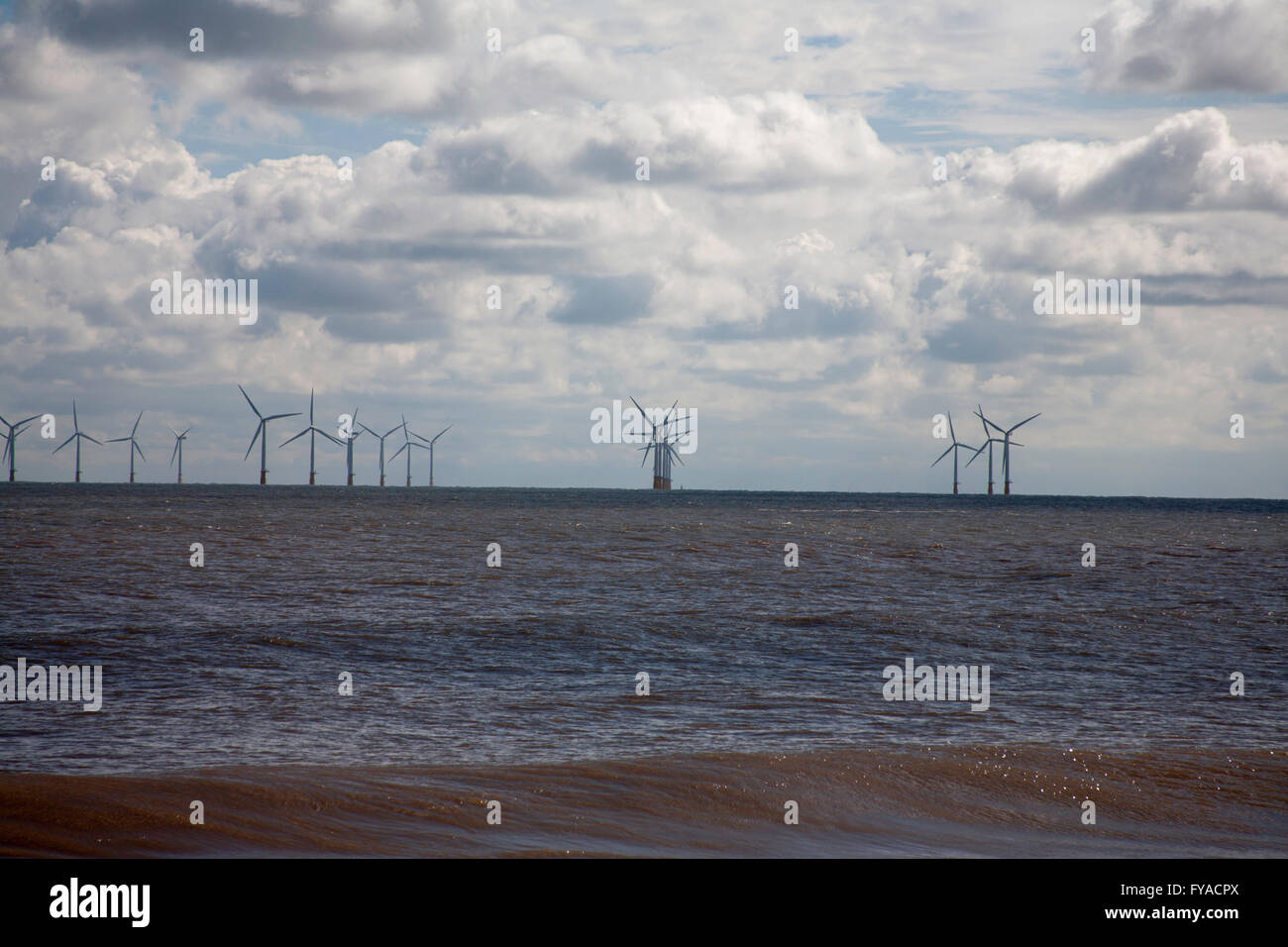 The beach with wind farm in the background Skegness Lincolnshire England Stock Photo