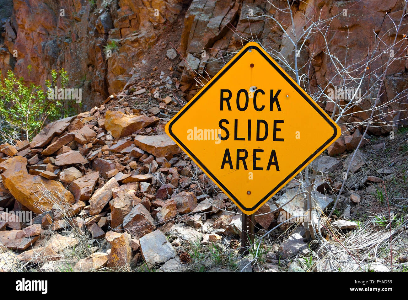 Rock Slide Area Sign with Fallen Rocks Stock Photo