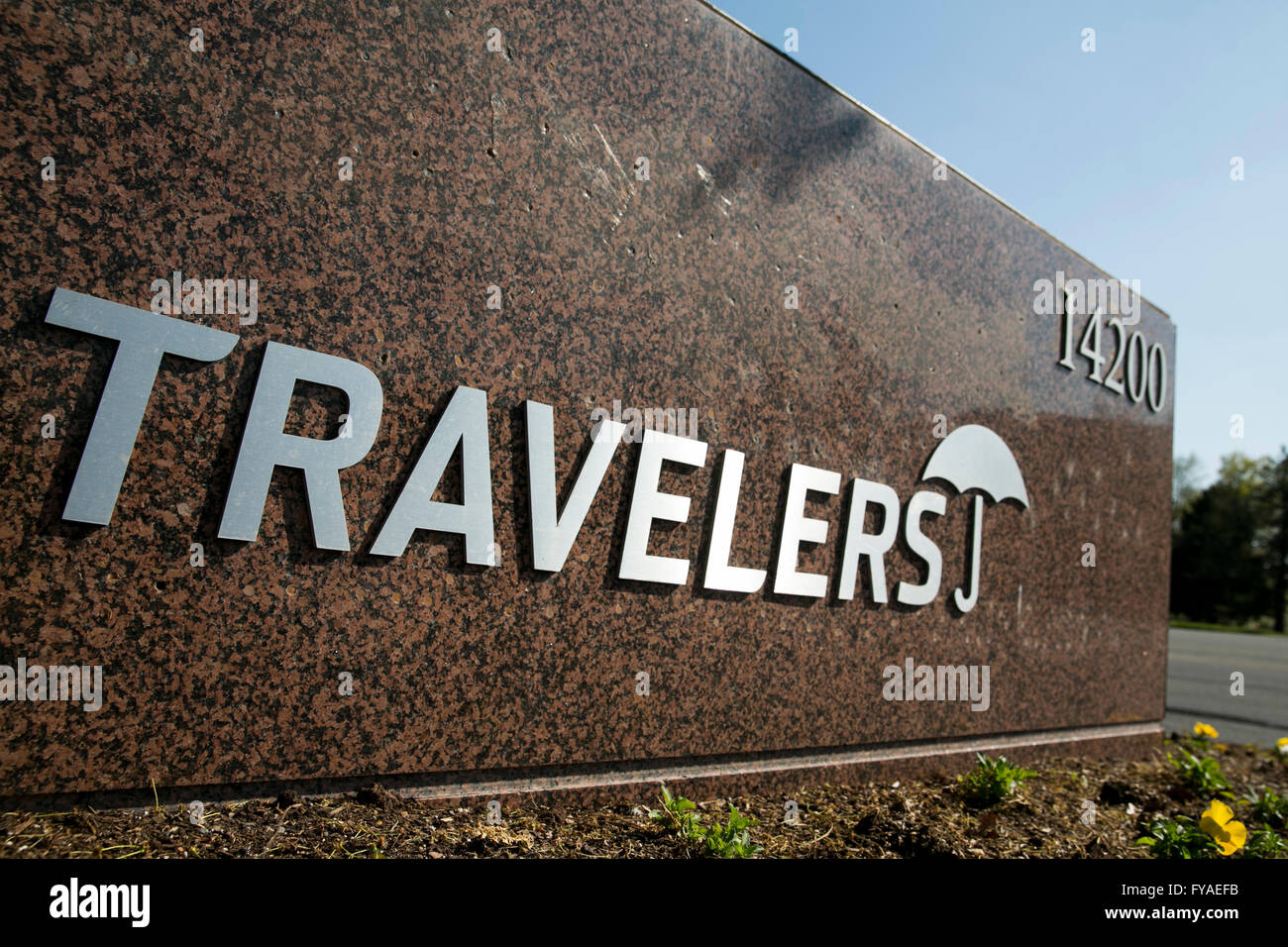 A logo sign outside of a facility occupied by The Travelers Companies