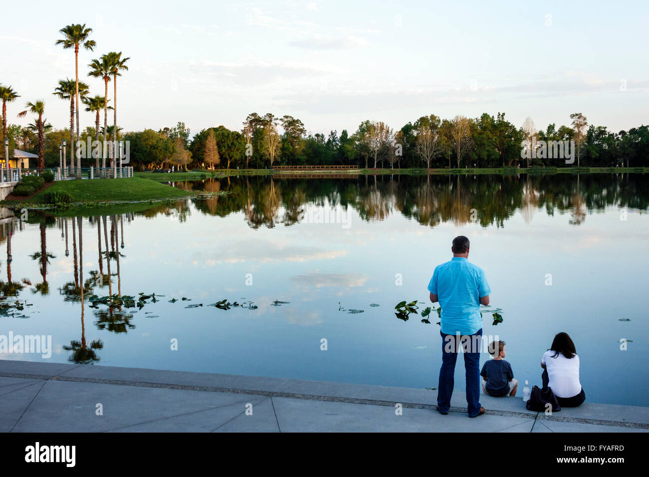 Orlando Florida,master-planned community,neo-urbanism,downtown,Front Street,Lake Rianhard,scenery,water,family families parent parents child male boy Stock Photo