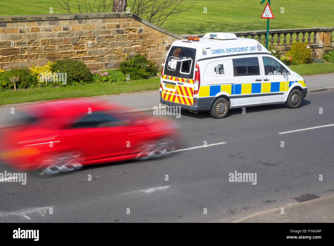 Police van Camera Enforcement Unit covert measuring of motor vehicle speed to check speed limit compliance red car speeding by Stock Photo