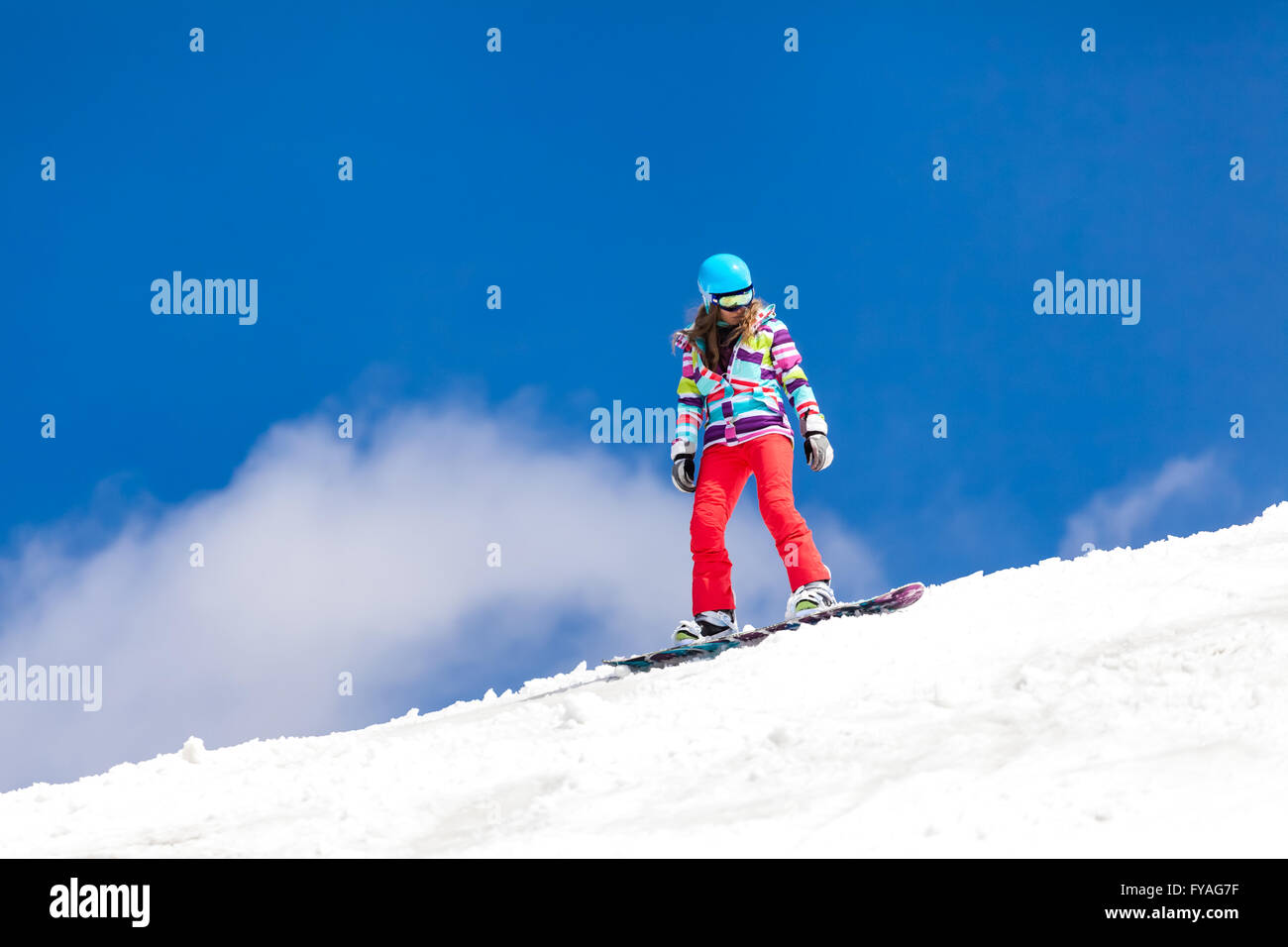 woman on snowboard in a beautiful day in winter on slope Stock Photo