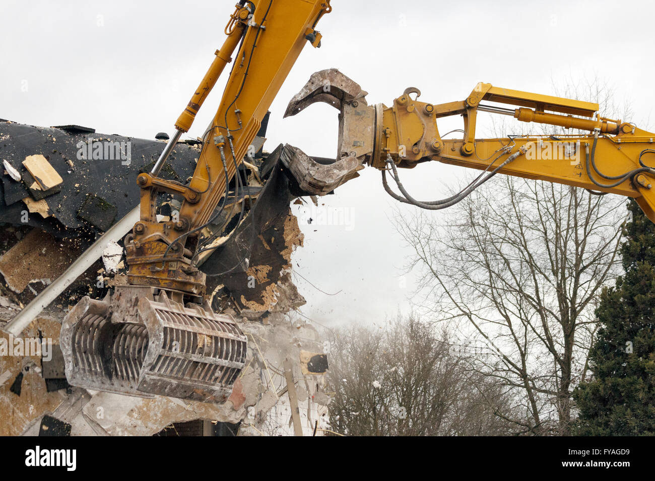 Demolition cranes dismantling a building Stock Photo