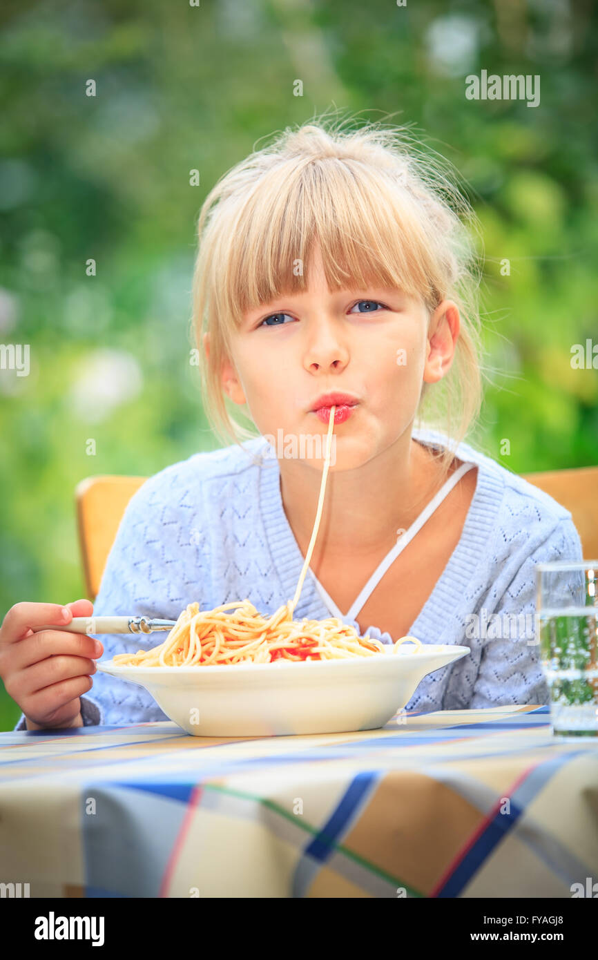 girl eating spaghetti in the garden Stock Photo Alamy