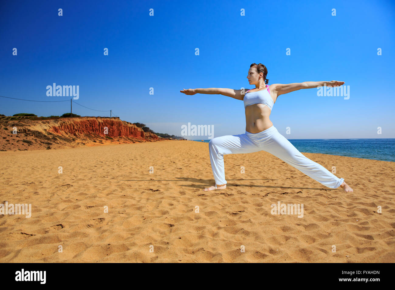 young woman making yoga exercise at a lake Stock Photo - Alamy