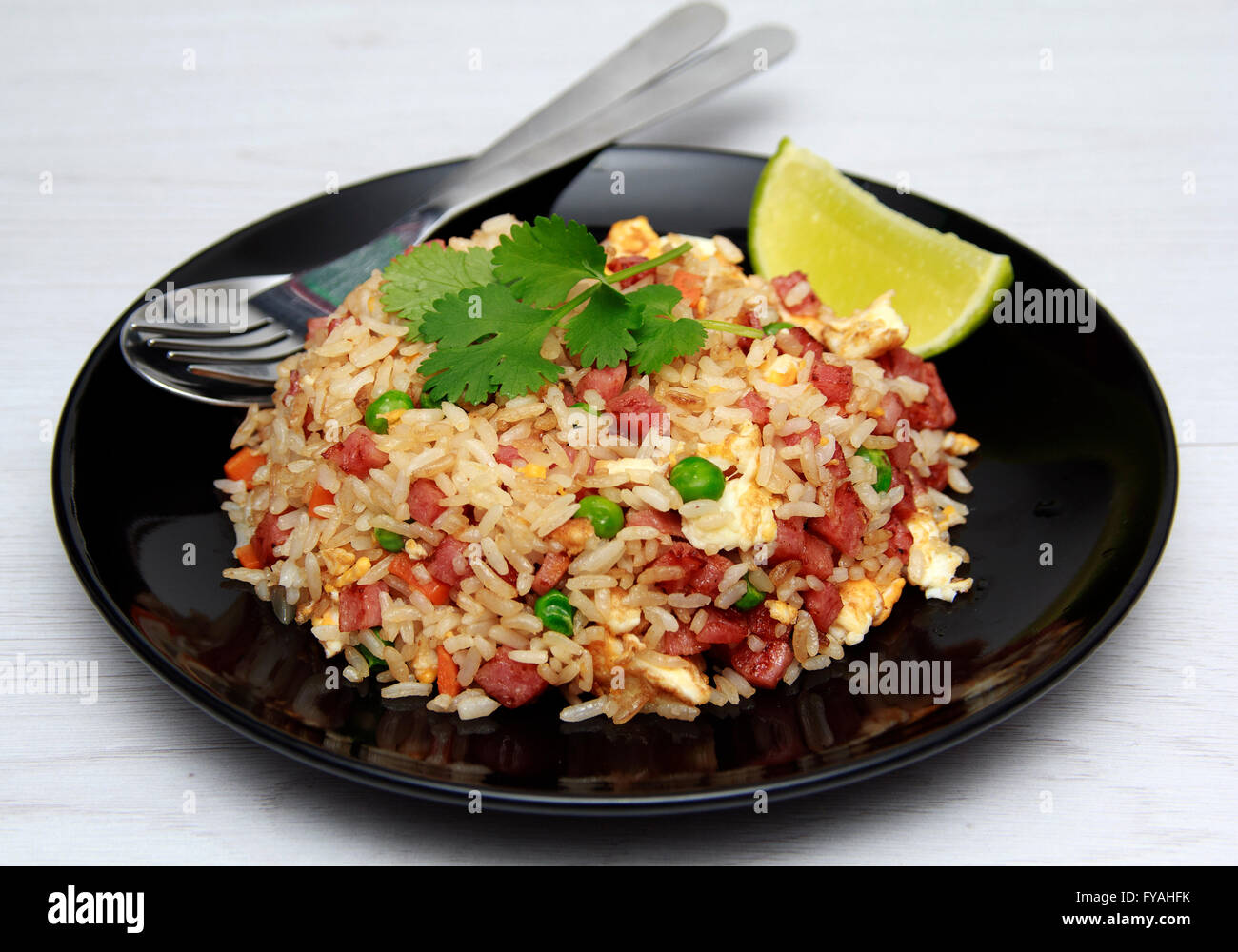 Dice Bacon Fried rice in black dish Stock Photo