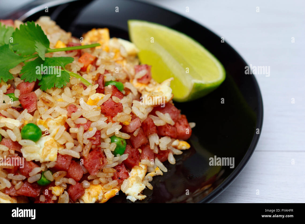 Dice Bacon Fried rice in black dish Stock Photo