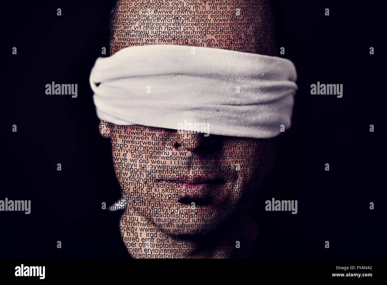 closeup of a young man patterned with no-sense words with a blindfold in his eyes, depicting the idea of lack of press freedom Stock Photo