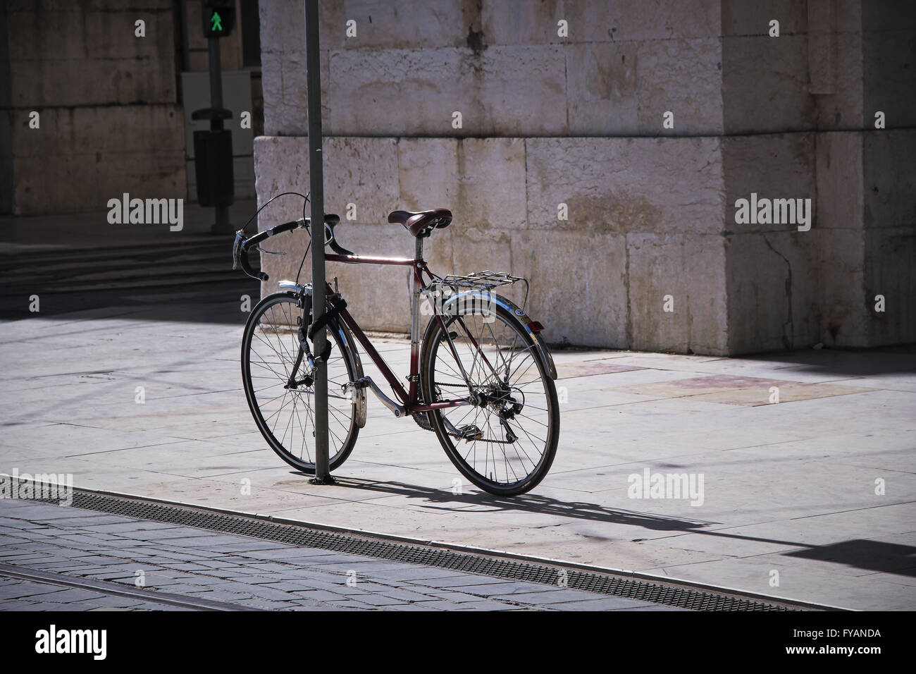 Bike affixed to a metal post in lisbon. Stock Photo
