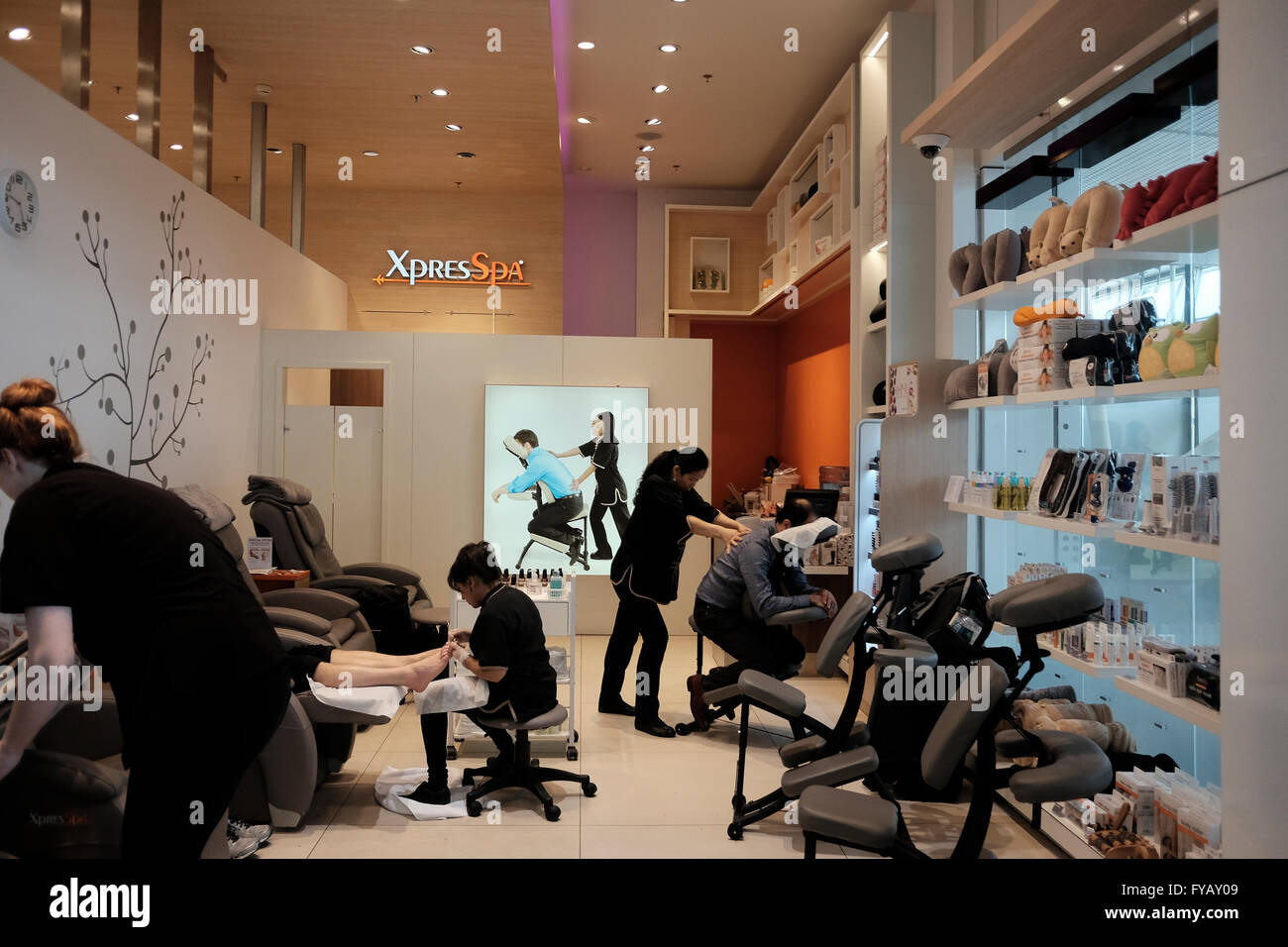 Passengers having massage and pedicure in a beauty salon in Schiphol airport in Amsterdam Netherlands Stock Photo