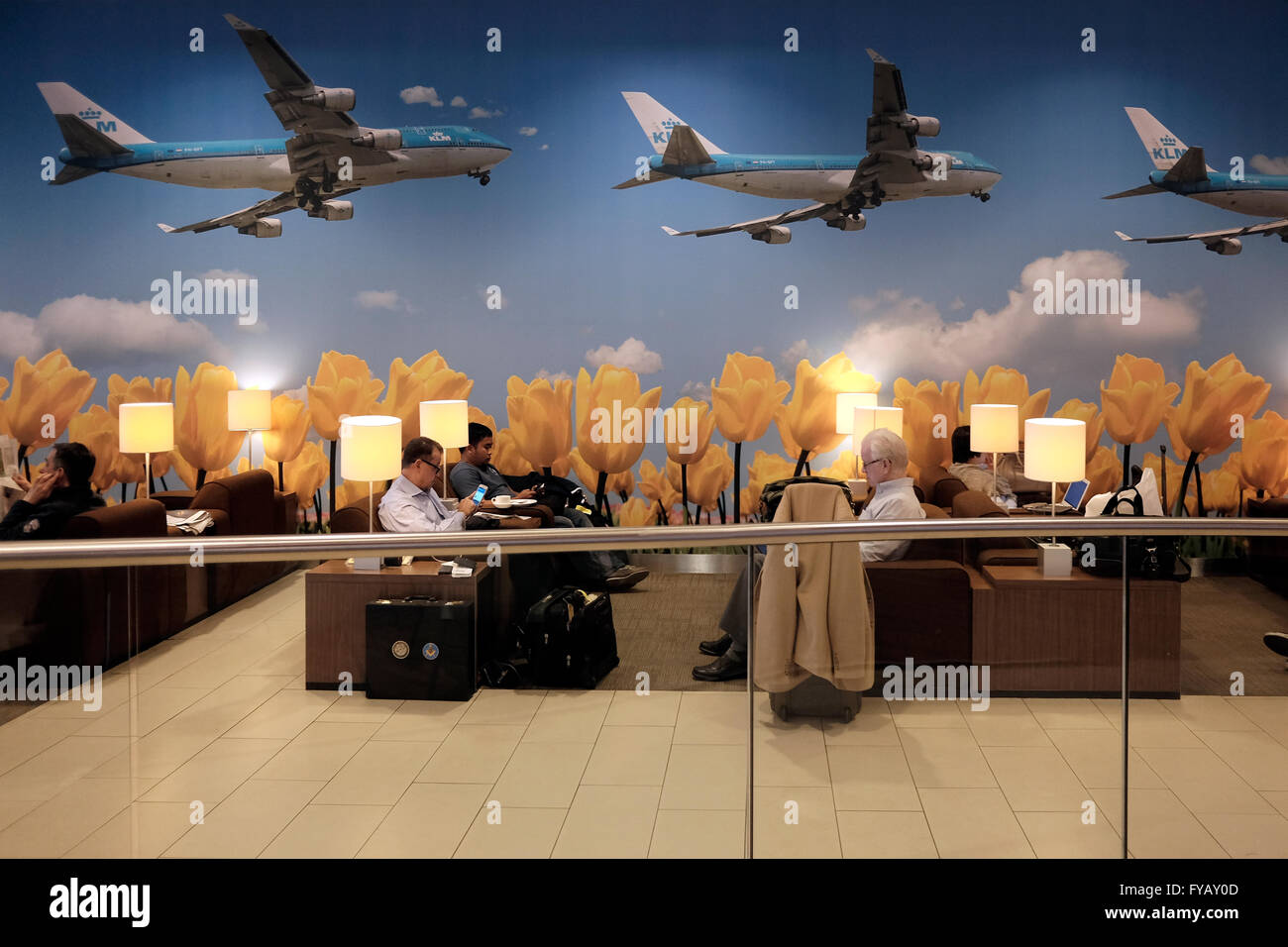 Passengers sitting at the KLM crown business lounge in Schiphol airport