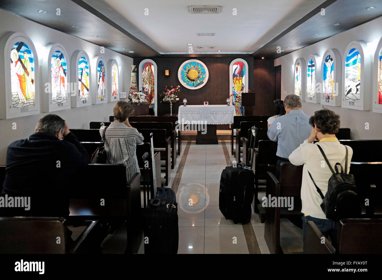Passengers pray in a small Catholic parish in Tocumen International Airport in Panama city Panama Stock Photo