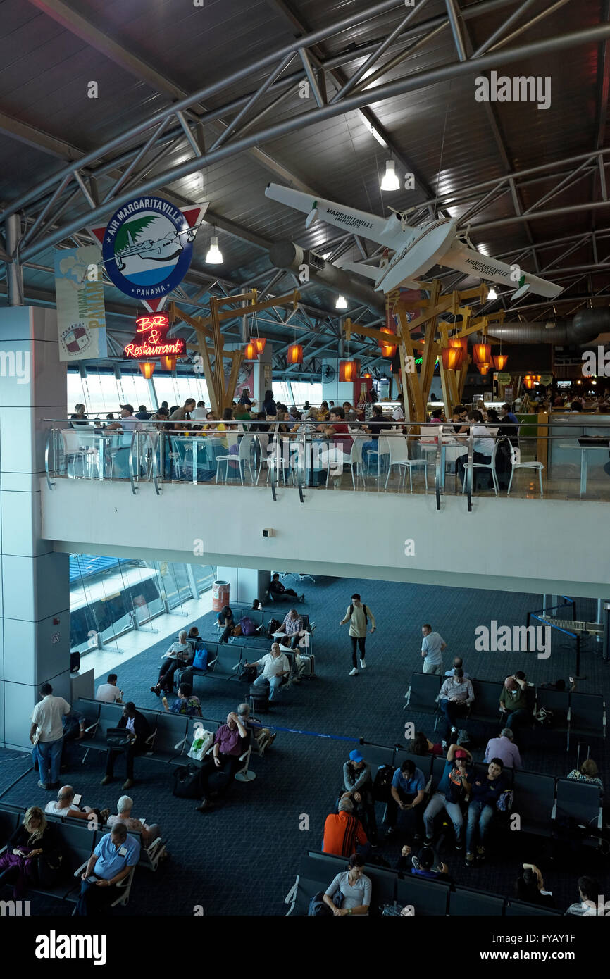 Passengers wait for their flight at the departure hall of Tocumen International Airport in Panama city Stock Photo