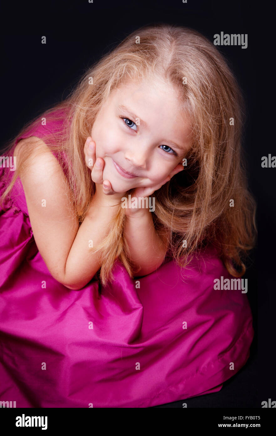 Portrait of a cute little girl in a pink dress in the studio Stock ...