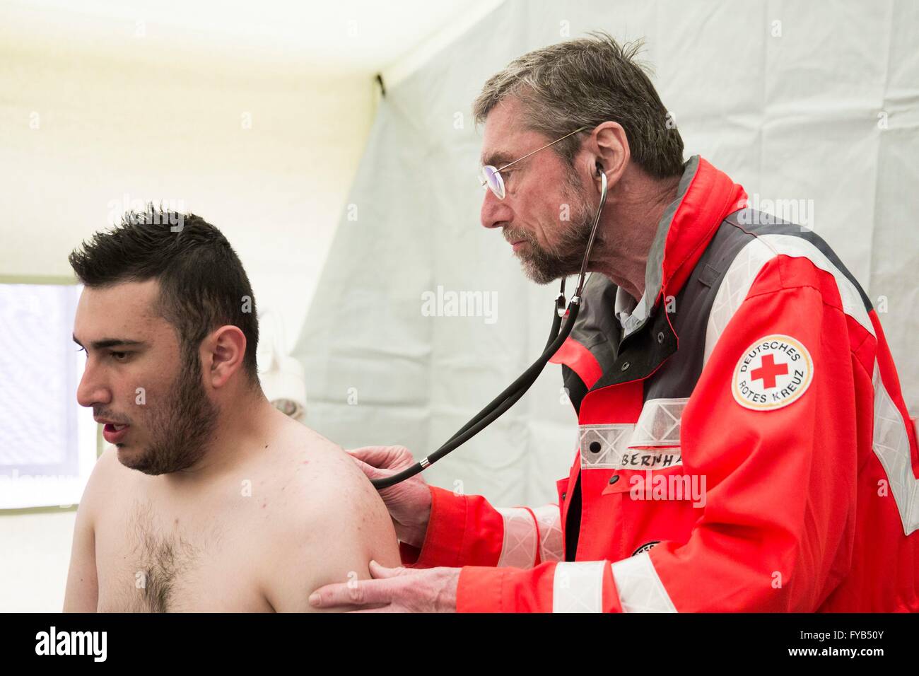Doctor Red Cross A German Red Cross doctor and a translator work in a basic health care ...