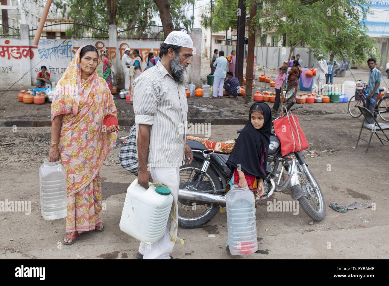 Latur, Maharashtra. 20th Apr, 2016. 20 April 2016 - Latur - INDIA.Unable to fetch water because of long queues Sayed Jafur, leaves a water tank in Latur on his motorbike, accompanied by his wife Khatumbi, and his 9-year-old granddaughter, Asha.Latur is part of the state's predominantly agricultural Marathwada region, where 273 farmers committed suicide between January and March this year.The area is among the worst affected by the drought and some families in Latur have left for cities such as the state capital Mumbai, nearly 500 kilometres away. In Latur town, there are huge queues at Stock Photo