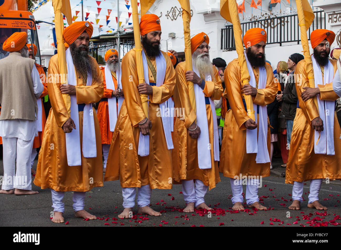 Slough, UK. 24th April 2016. The bearers of the Nishan Sahib and the Panj Pyare (Five Beloved Ones) begin the Vaisakhi Nagar Kirtan procession from the Gurdwara Sri Guru Singh Sabha. Vaisakhi is the holiest day in the Sikh calendar, a harvest festival marking the creation of the community of initiated Sikhs known as the Khalsa. Credit:  Mark Kerrison/Alamy Live News Stock Photo