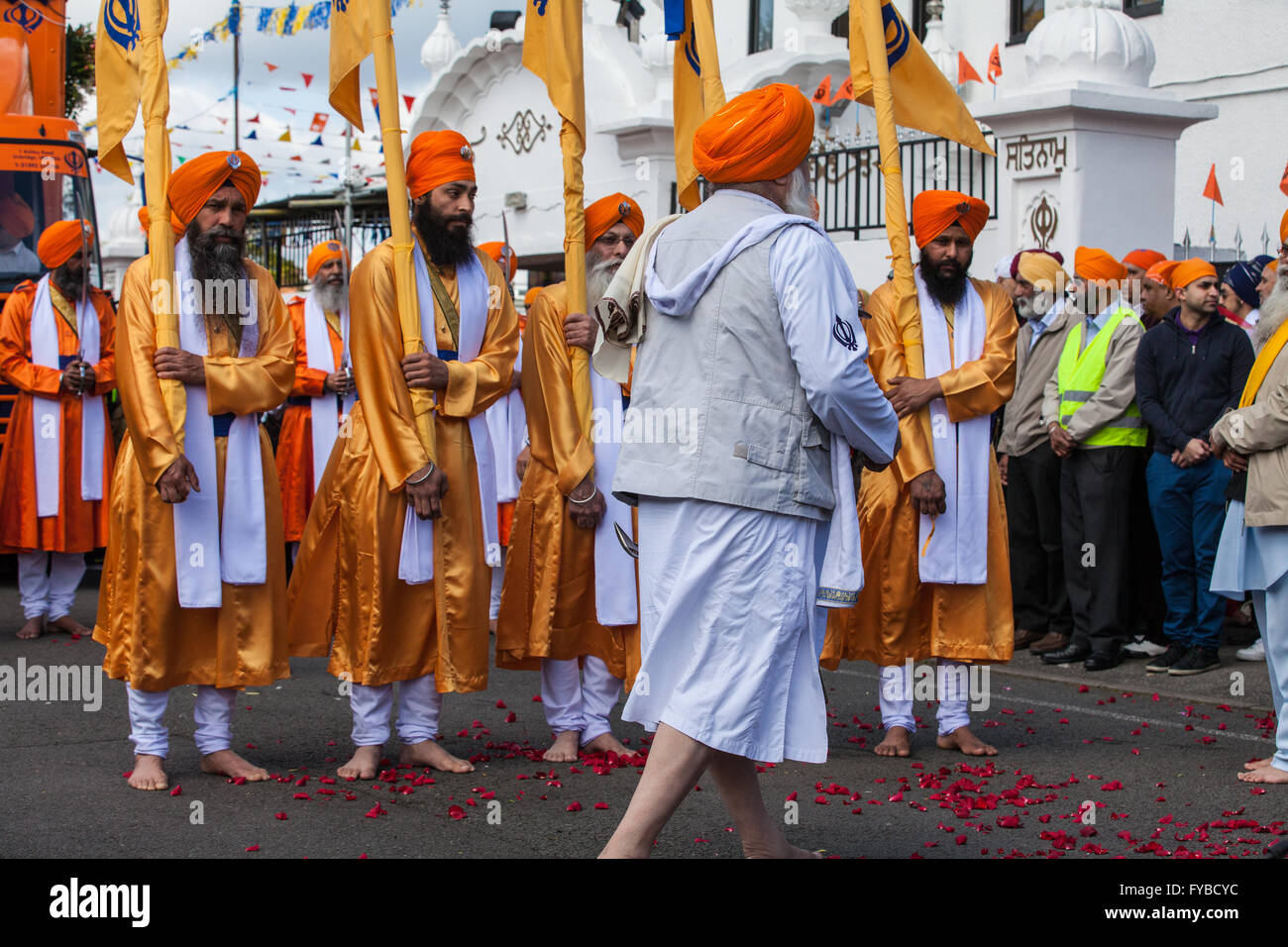 Slough, UK. 24th April 2016. The bearers of the Nishan Sahib and the Panj Pyare (Five Beloved Ones) begin the Vaisakhi Nagar Kirtan procession from the Gurdwara Sri Guru Singh Sabha. Vaisakhi is the holiest day in the Sikh calendar, a harvest festival marking the creation of the community of initiated Sikhs known as the Khalsa. Credit:  Mark Kerrison/Alamy Live News Stock Photo