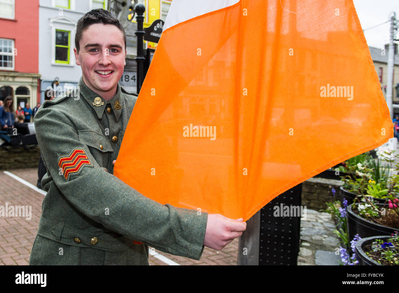 Skibbereen, Ireland. 24th April, 2016. Ian Lynch, a direct descendant of Gearóid O'Sullivan who was involved in the 1916 rising, prepares the Irish Tricolour for raising at the school's Proclamation Day event to commemorate 100 years since the start of the rebellion in Dublin. Credit: Andy Gibson/Alamy Live News Stock Photo