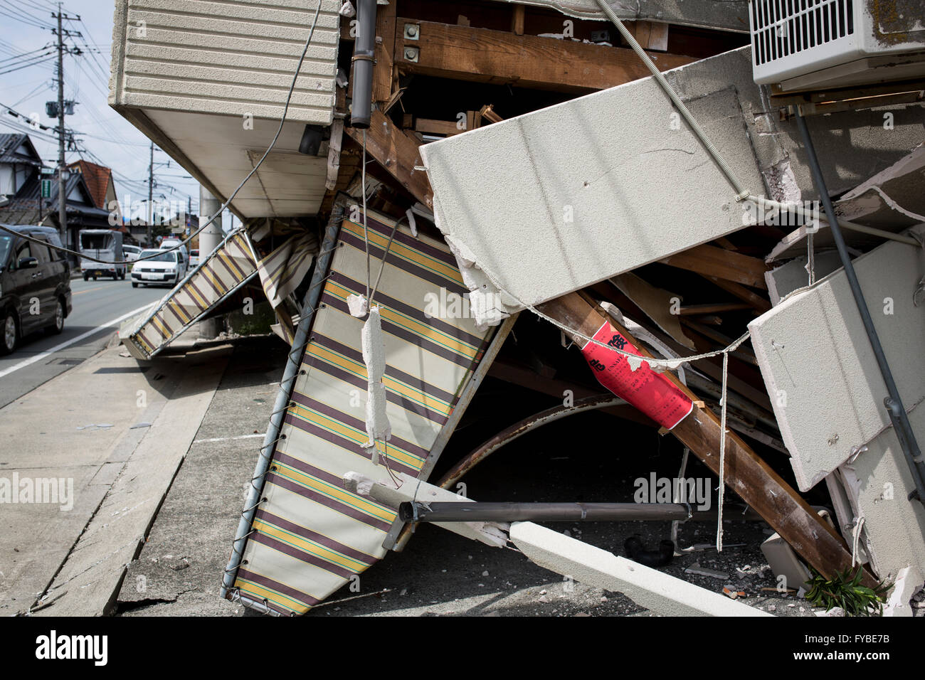 KUMAMOTO, JAPAN - APRIL 22: An 'unsafe' notice is stuck to a damaged ...