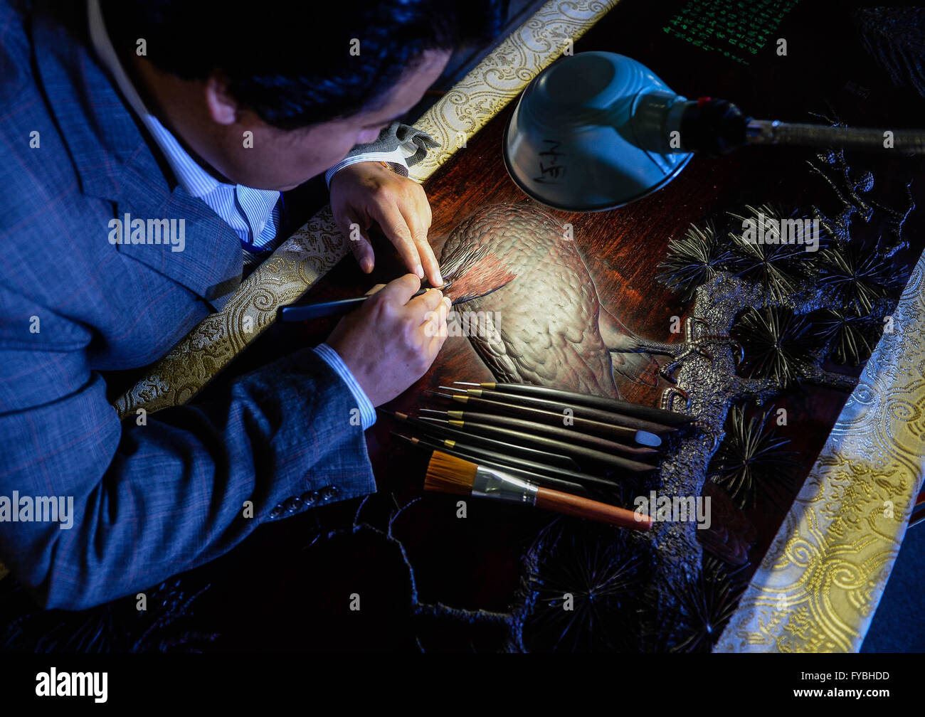 Wuxi, China's Jiangsu Province. 25th Apr, 2016. Wood carving art master Chen Jiaguo makes a piece of artwork of sandalwood carving during a traditional skills fair in Wuxi, east China's Jiangsu Province, April 25, 2016. A total of 47 artists took part in the fair here on Monday. Credit:  Ji Chunpeng/Xinhua/Alamy Live News Stock Photo