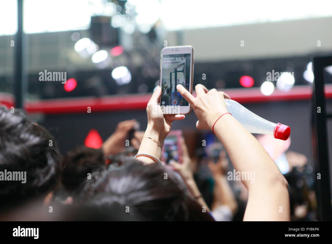 Beijing, China. Monday, 25 April 2016. audience use mobile phone taking pictures at 2016 Beijing International Automotive Exhibition. Credit:  Shui Ta Shan/Alamy Live News Stock Photo