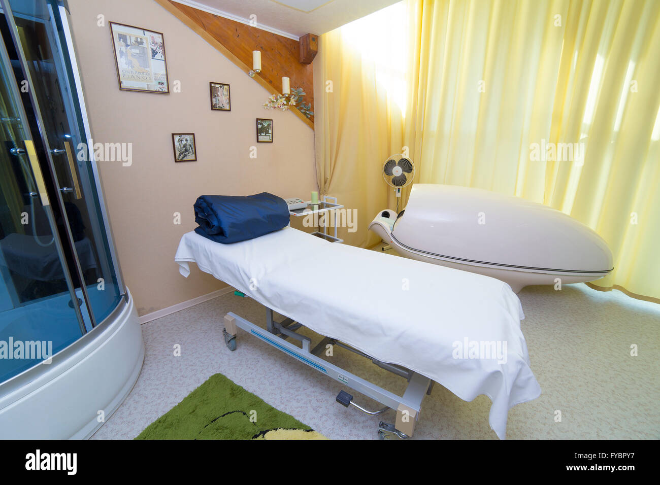 SPA salon with Solarium capsule, massage table and shower Stock Photo Alamy