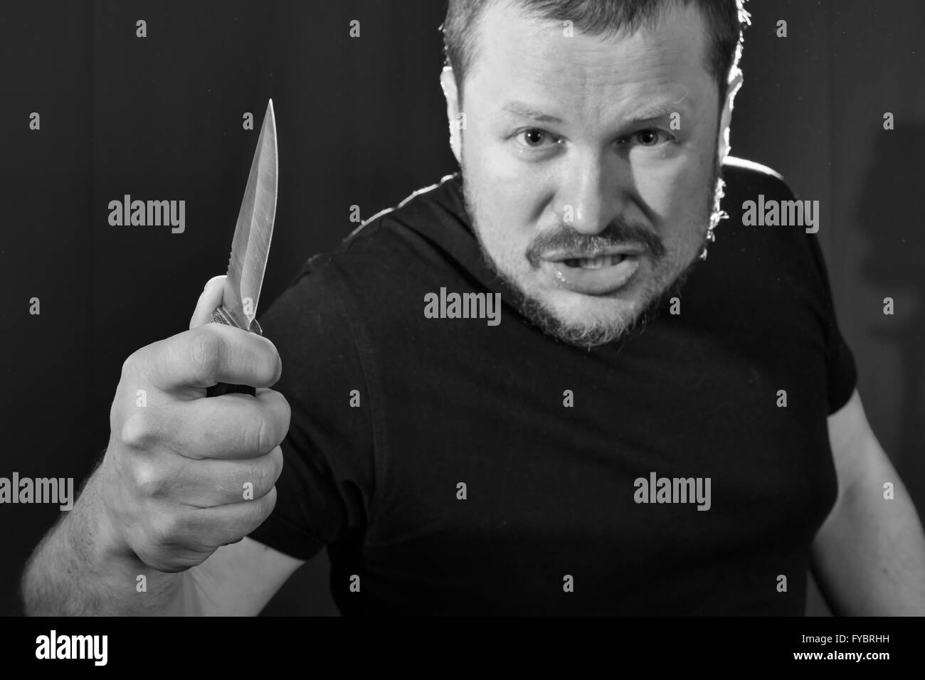 Portrait of a gangster with a knife low key Stock Photo - Alamy