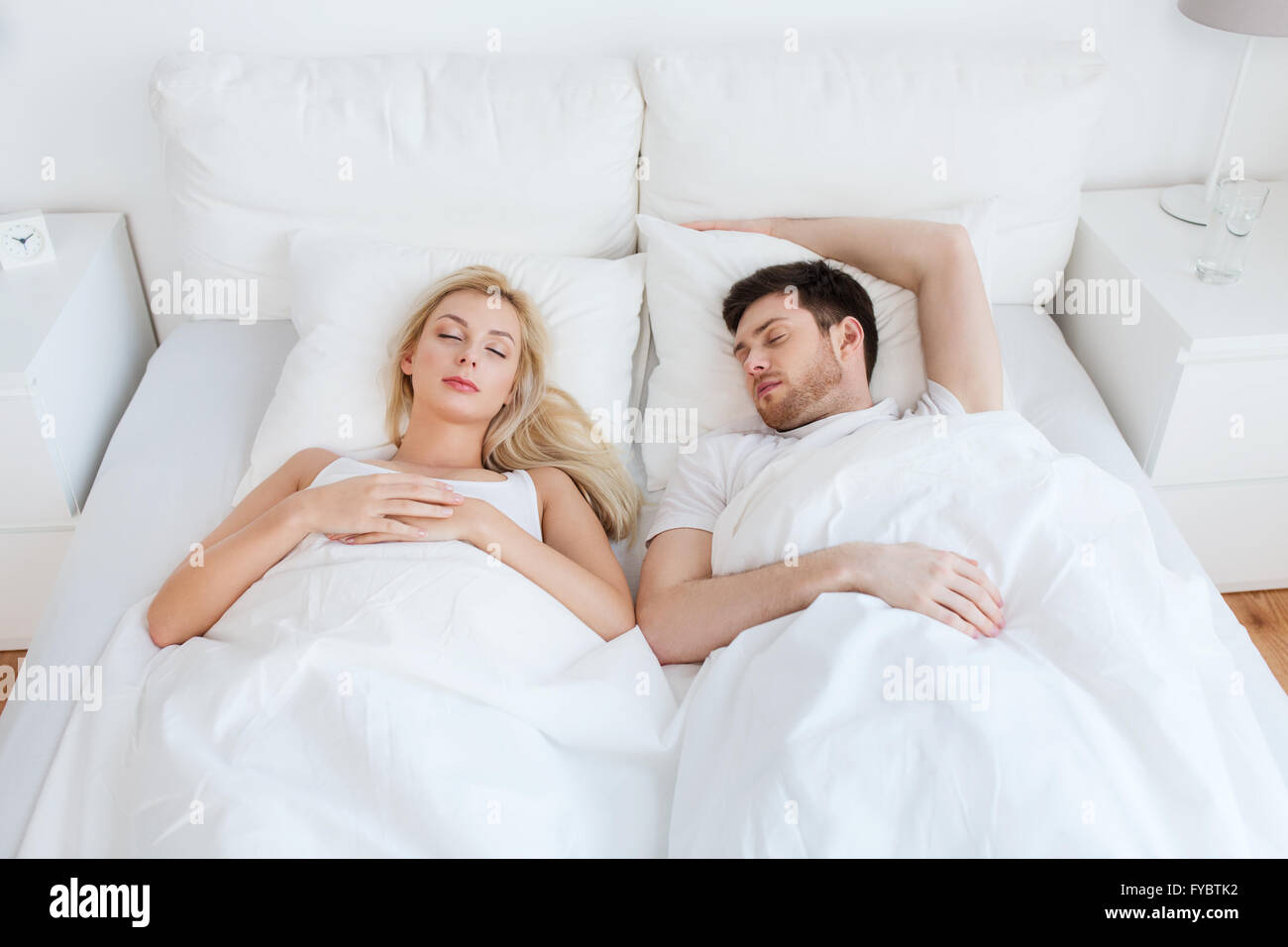 happy couple sleeping in bed at home Stock Photo - Alamy