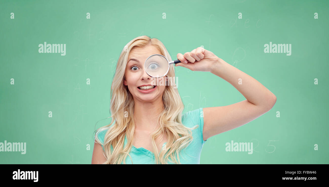 happy young woman with magnifying glass Stock Photo - Alamy