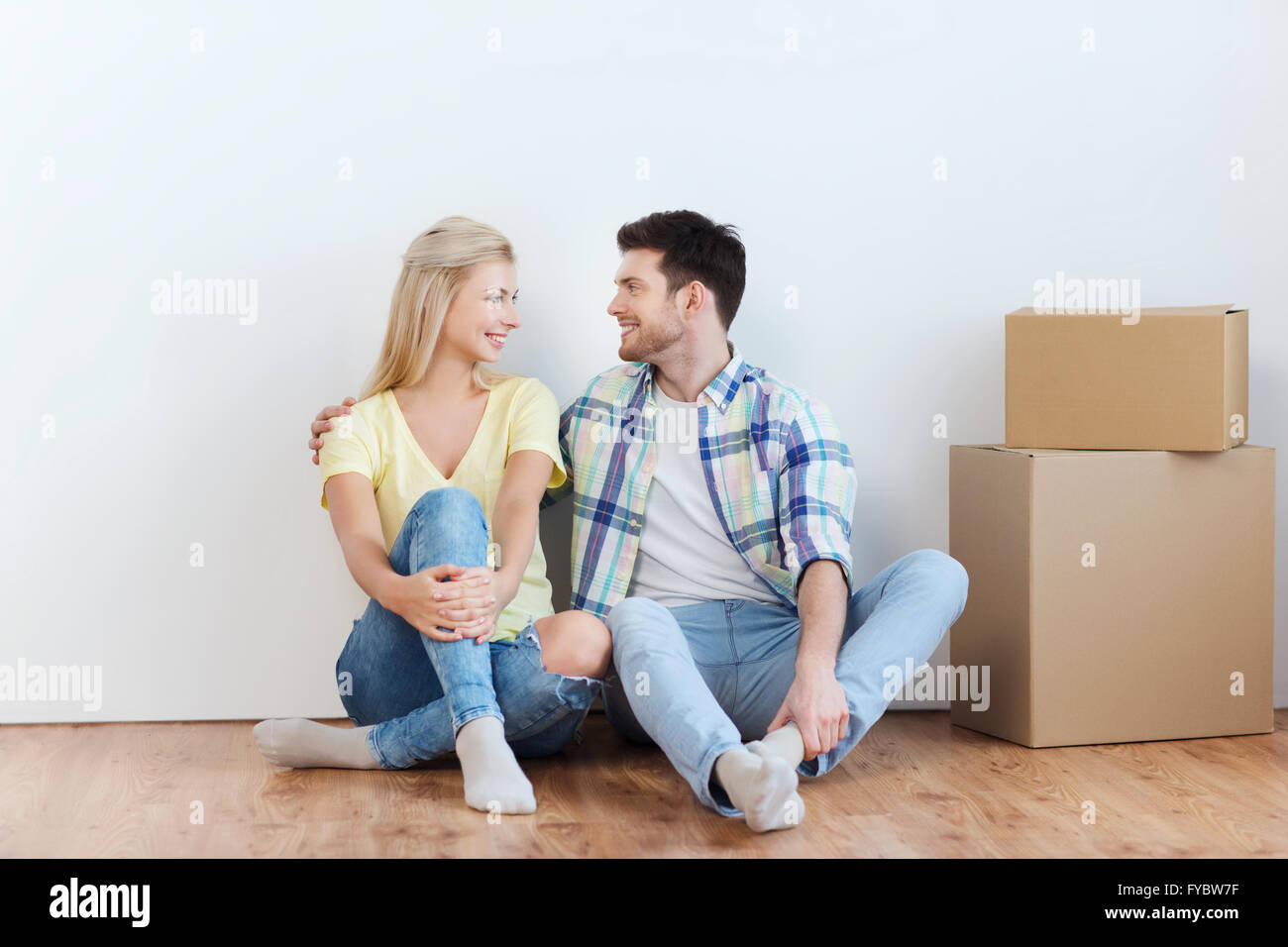 couple with cardboard boxes moving to new home Stock Photo - Alamy