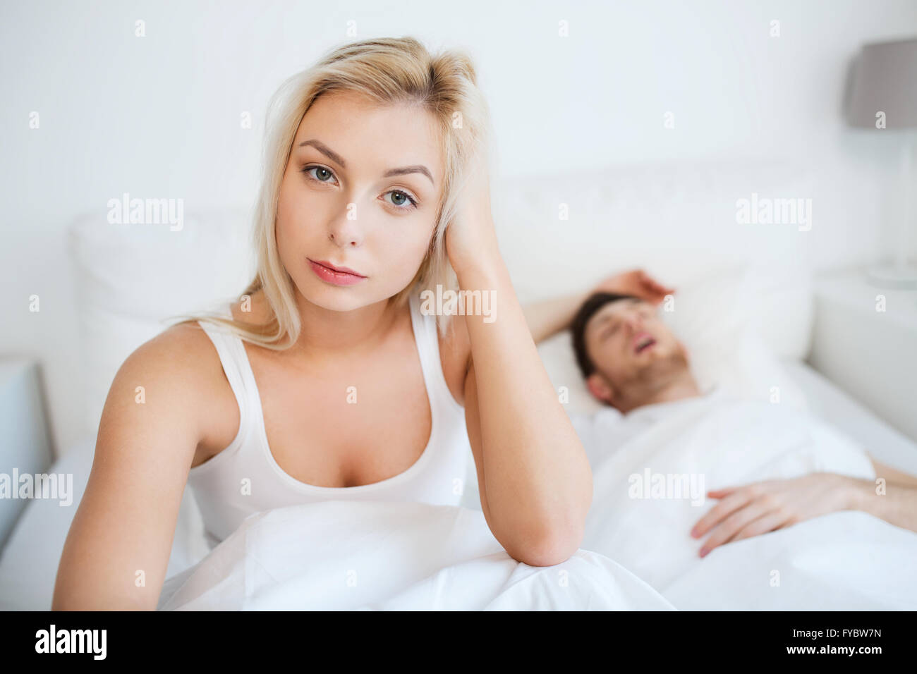 awake woman having insomnia in bed Stock Photo