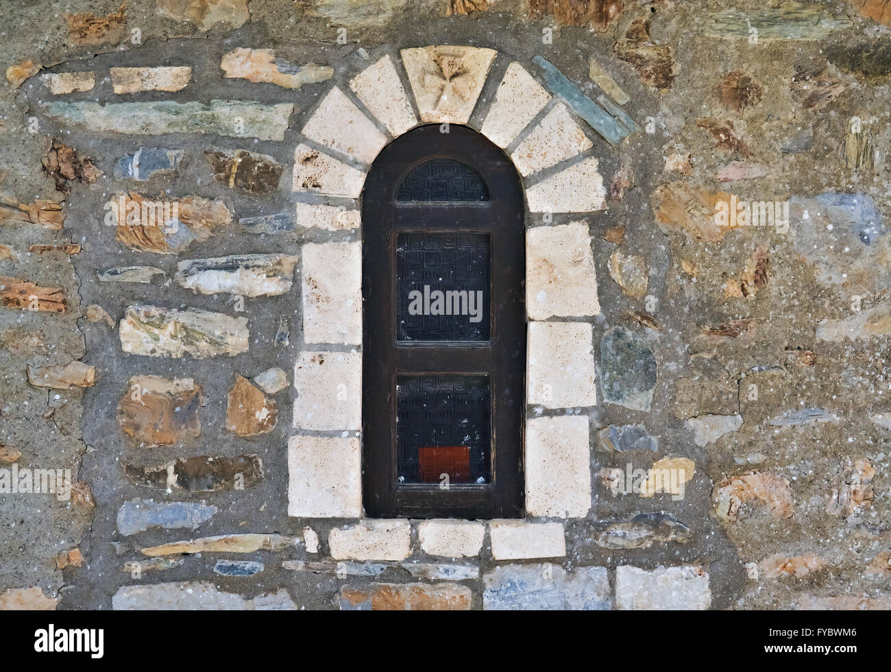 Mediterranean architecture detail with an old window and stone wall Stock Photo