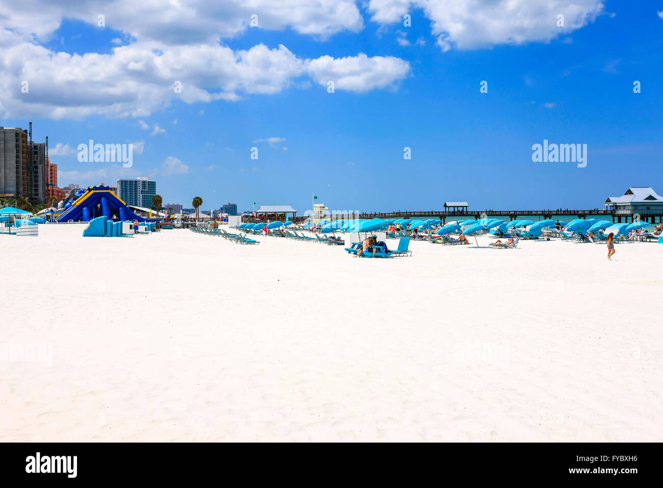 Blue umbrellas, cabanas and people on Clearwater beach Florida, voted