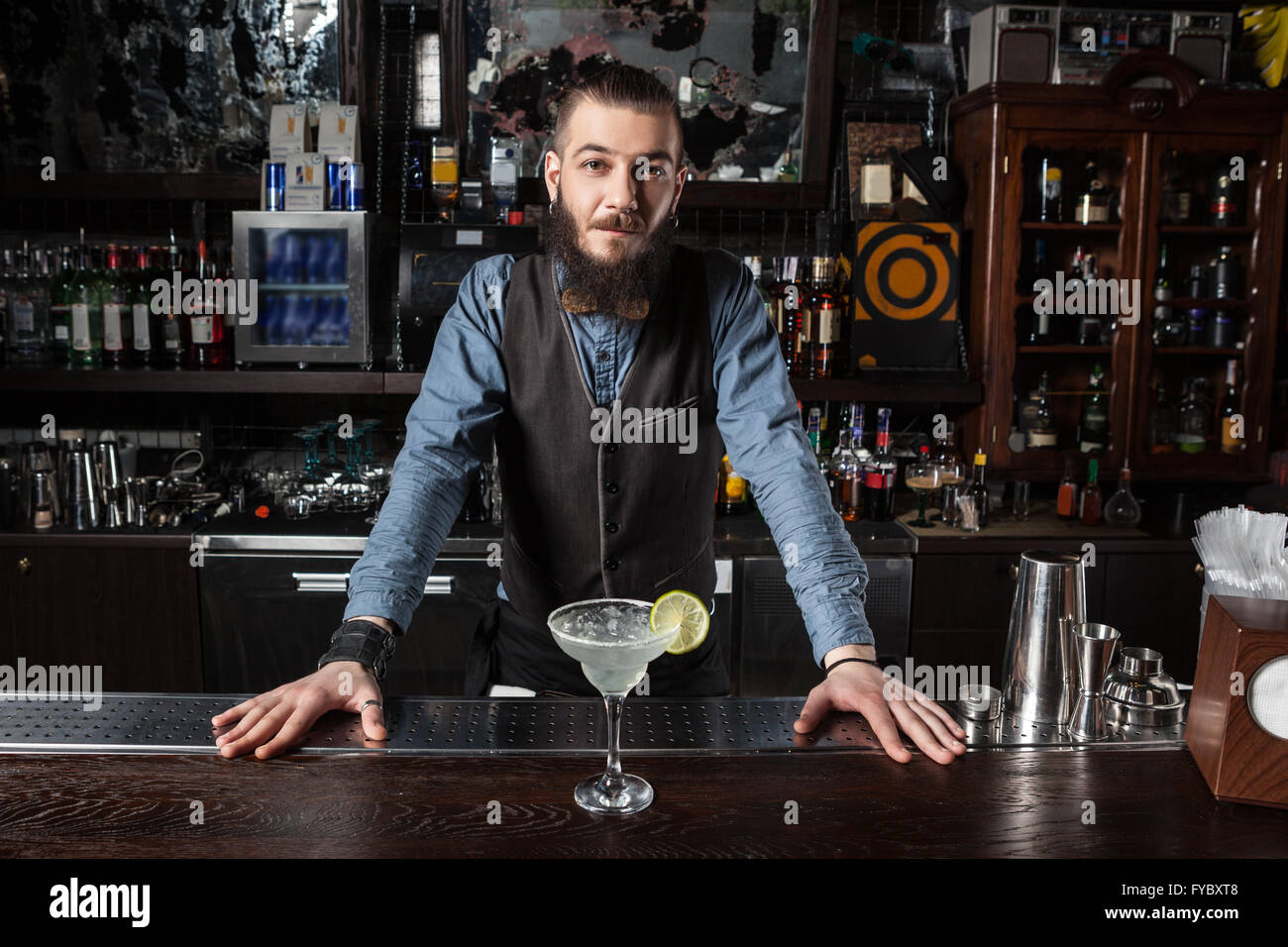 This is a photograph of barman serving cocktail margarita. Stock Photo