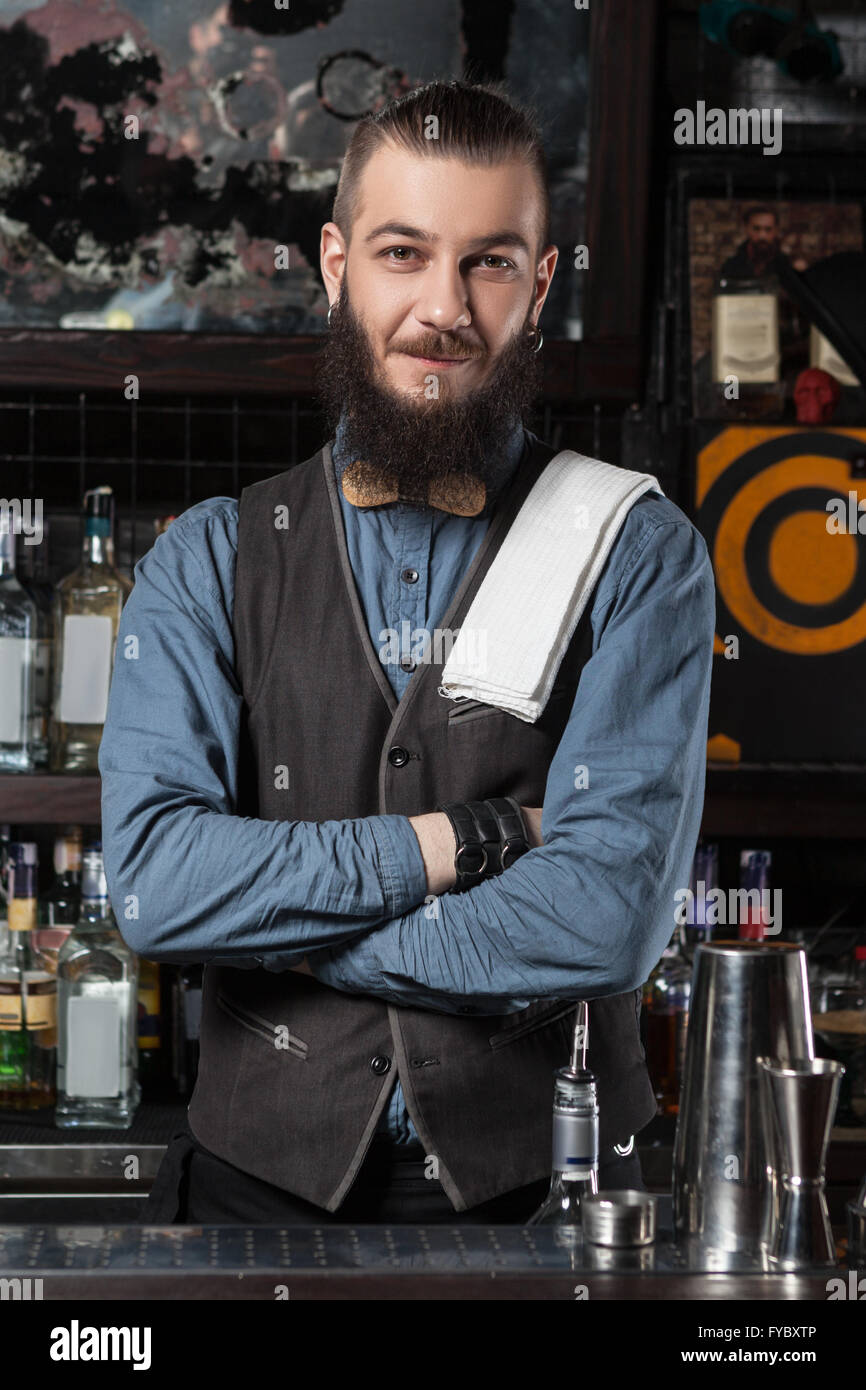 Happy barman at work with crossed hands. Stock Photo