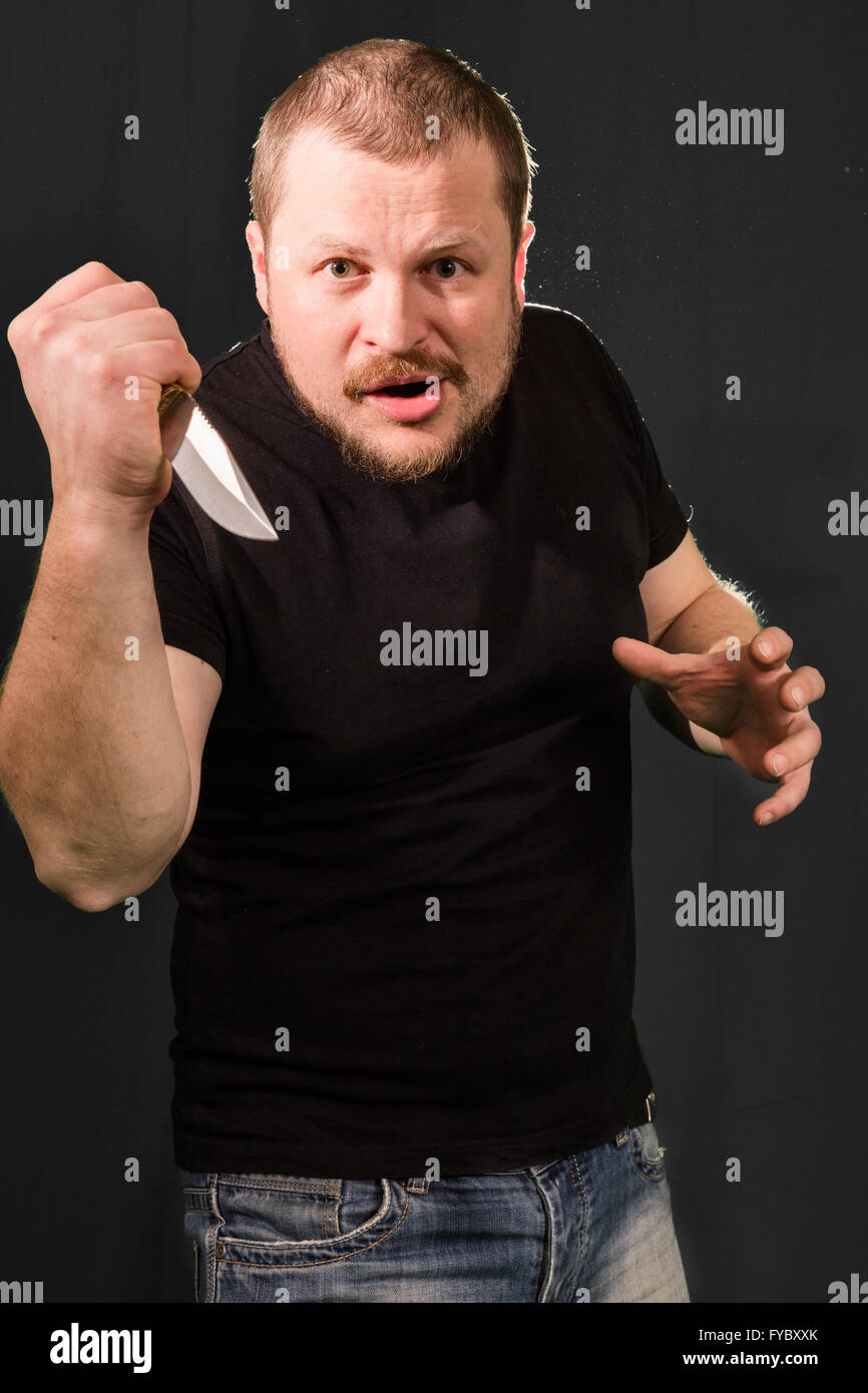 Portrait of a gangster with a knife low key Stock Photo - Alamy