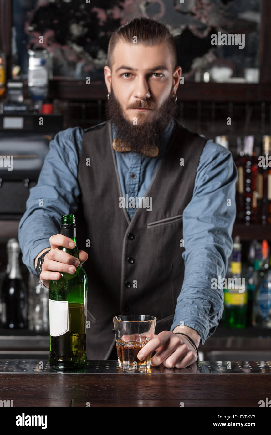 Severe Barman serving cocktail at the bar. Stock Photo